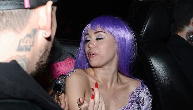 Miley Cyrus spotted with liquor bottle